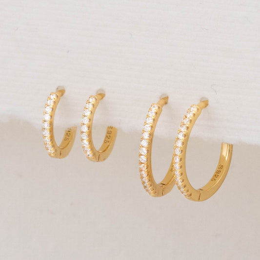 Front view of gold huggie hoops with micro pave diamonds, showing their delicate sparkle and style.