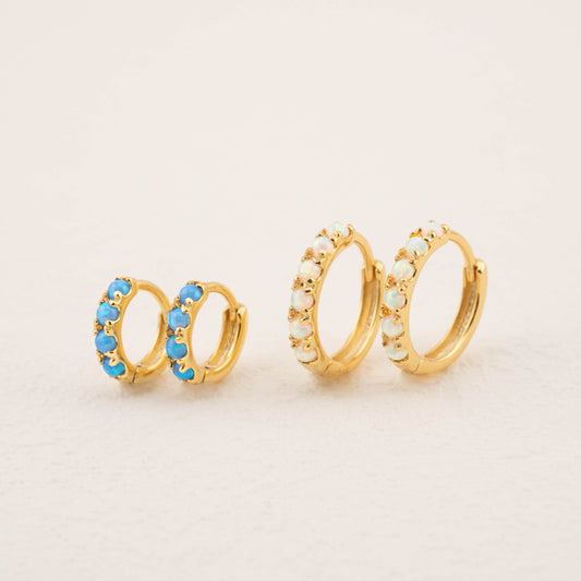 Earrings with opal: blue and white opal stones, displayed side by side.