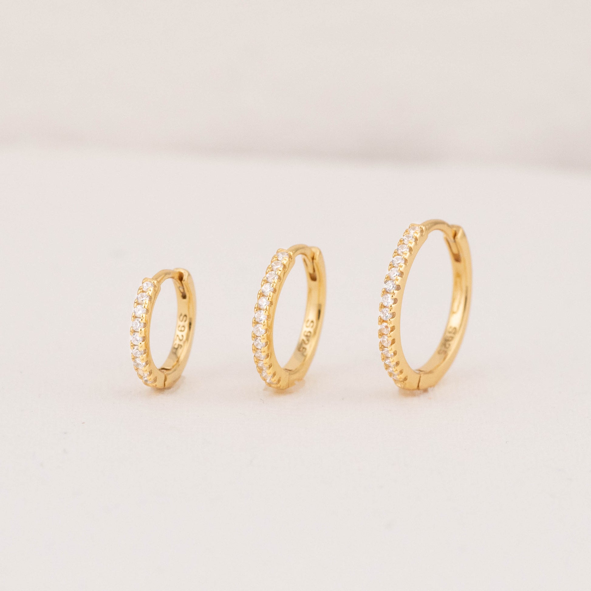 Pave hoop earrings in 8mm, 11mm, and 13.5mm sizes, ideal for trendy, simple diamond hoops.