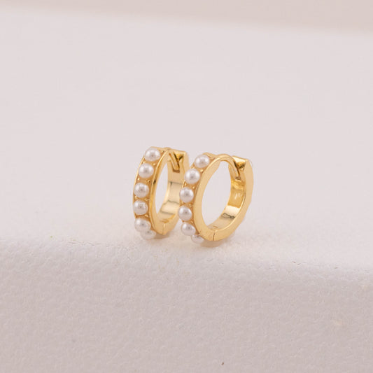 Tarnish-free earrings in gold with tiny pearls, highlighting their clean, bright finish.