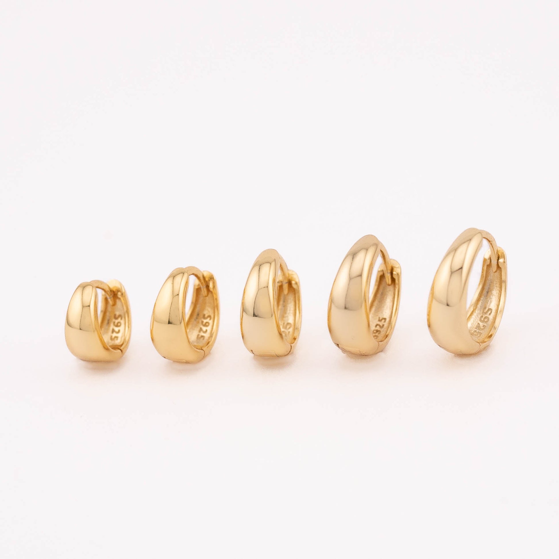 14K gold vermeil mini huggies (6mm-10mm) for men and women, neatly lined up in various sizes