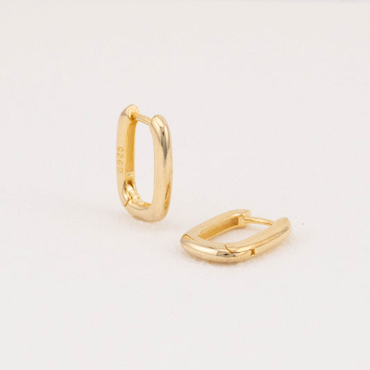 Mini rectangular 14K gold vermeil hoop earrings: one angled, one flat on white surface.